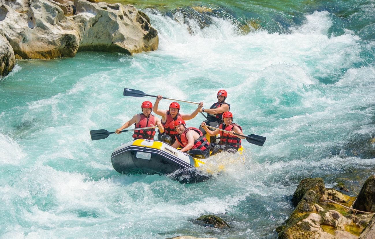 River rafting in Rishikesh on the Ganga with group navigating rapids
