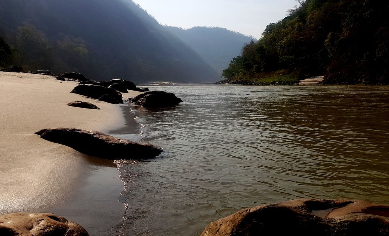 Ganga beach in Rishikesh with soft sand, clear river water and peaceful Himalayan surroundings