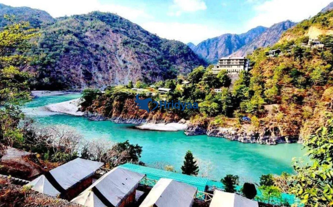 Riverside camping near Rishikesh with tents beside the Ganga in a quiet natural setting