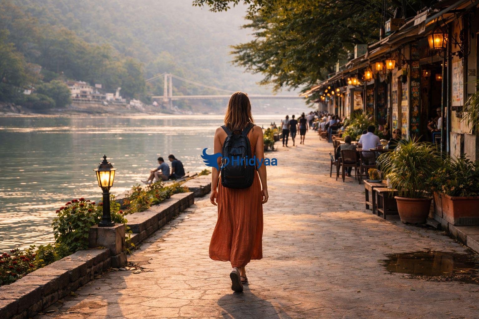 Solo traveler walking along a riverside path in Rishikesh
