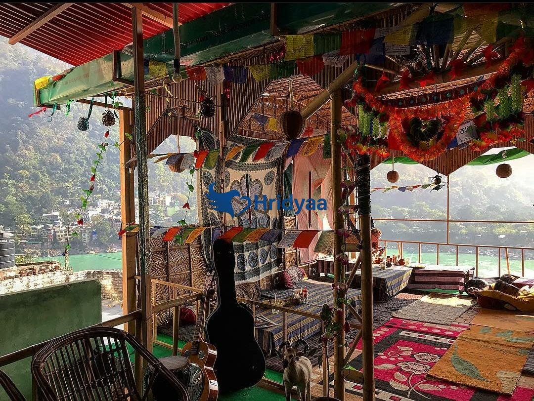 freedom cafe perched above ganga river with panoramic valley views